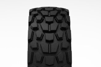Black off-road tire with prominent tread pattern on a white background
